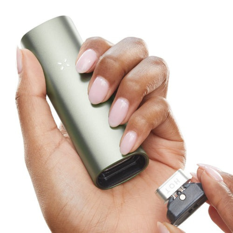 Hand holding Pax 3 Vaporizer for use